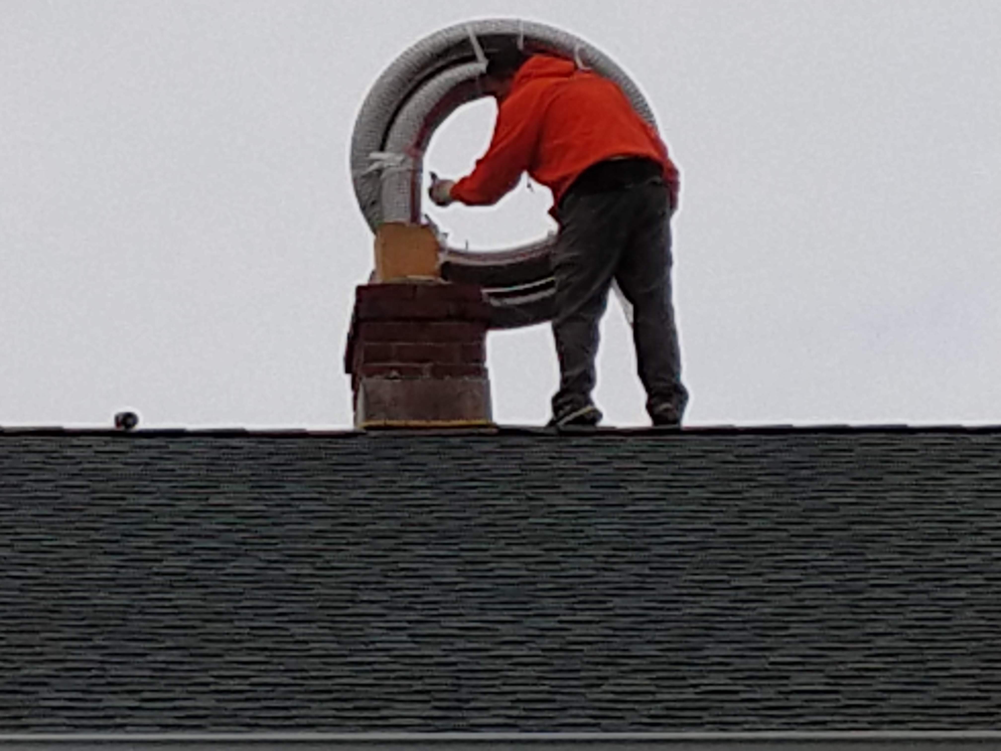 Flexible stainless chimney liner being installed in Jericho, New York